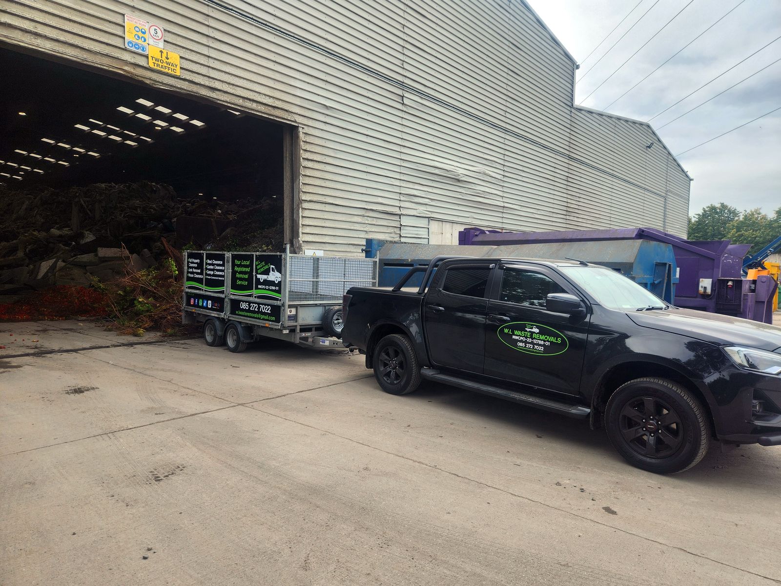 Pickup and trailer at a recycling facility