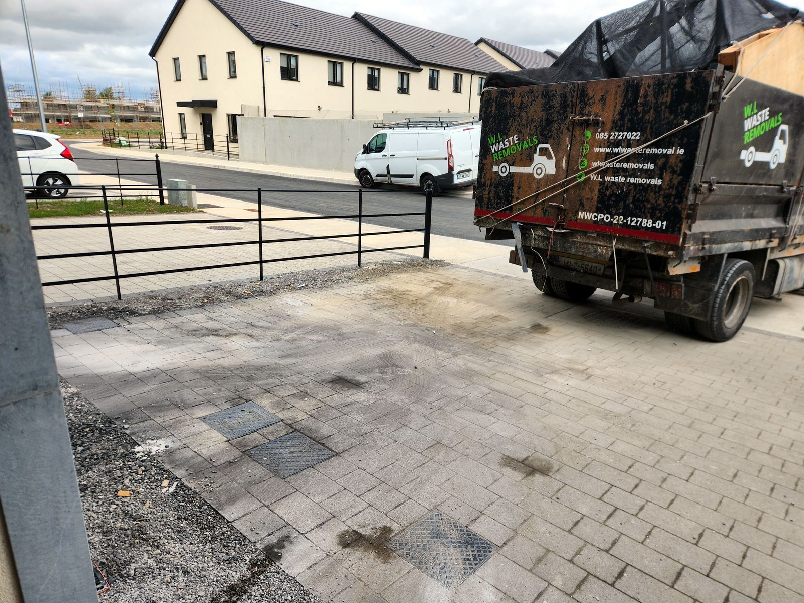 The same paved area cleared, with the loaded truck alongside