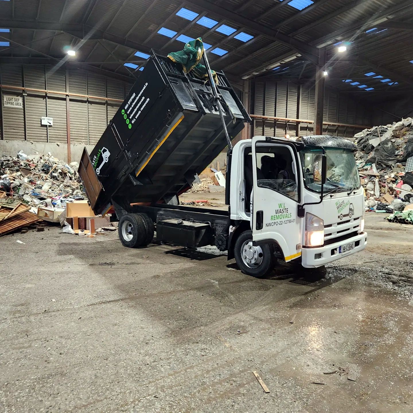 Tipper truck unloading at a waste facility